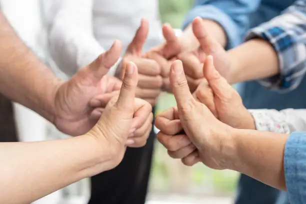 Photo of Businessman and business thumbs up as successful business achievement. Business people hit target or goal. Business agreement deal. Teamwork conceptual.