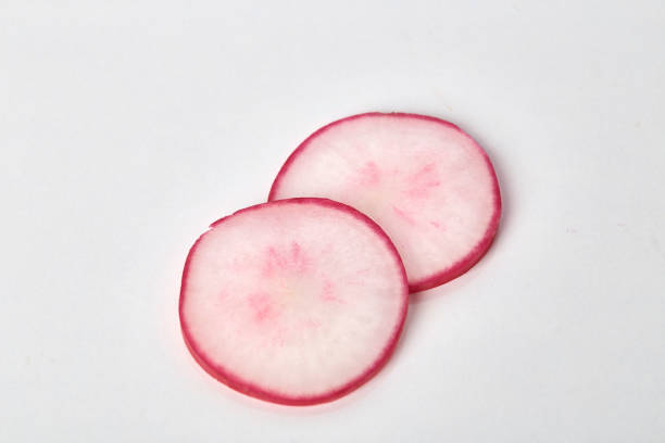 istock Garden fresh red radish slices on white background 1014896734