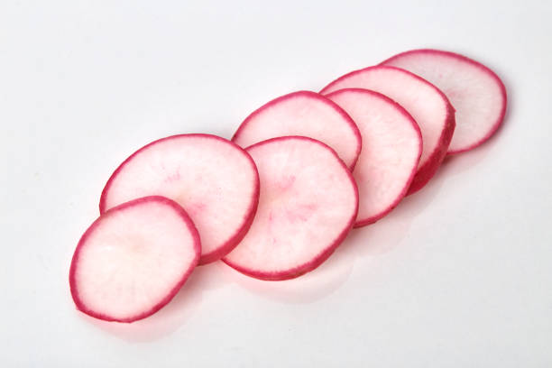 istock Garden fresh red radish slices on white background 1014896816
