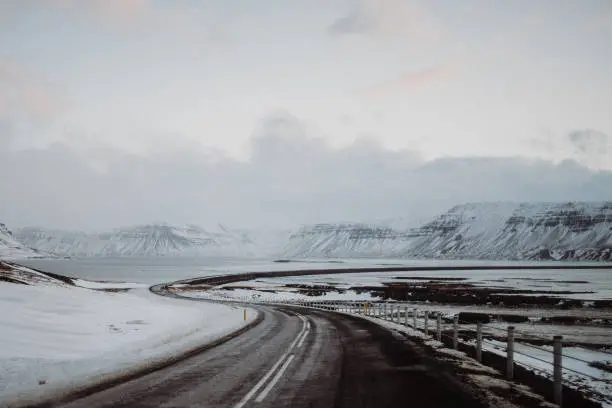 A curvy road in Iceland going through a snowy landscape