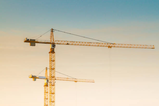 istock Construction cranes at a construction site at sunset in early spring 1014903274