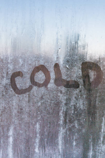 istock The inscription is cold on a frozen window with patterns 1014911830