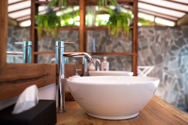Close up image of a water faucet and a sink.