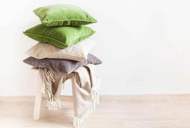 istock gray and green cushions, throw. cozy home 1014916042
