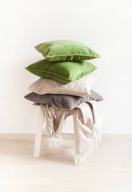 istock gray and green cushions, throw. cozy home 1014916704