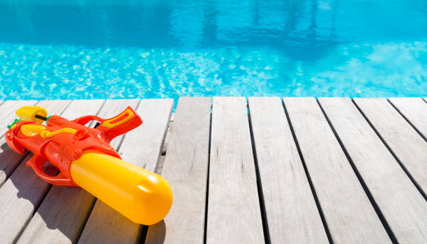istock Colorful Water Gun By The Swimming Pool 1014930264