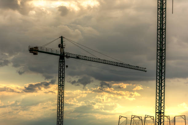 istock Cranes in the sunset, end of the workday in the work 1014931022