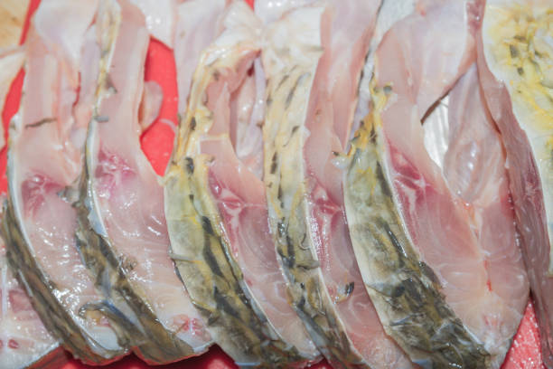 istock Cleaning fresh fish carp from scales with a special knife 1014931074