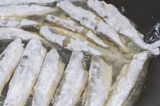 istock Cooking fried fish smelt rolled in flour 1014933676