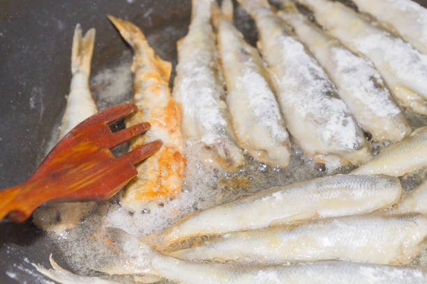 istock Cooking fried fish smelt rolled in flour 1014933716