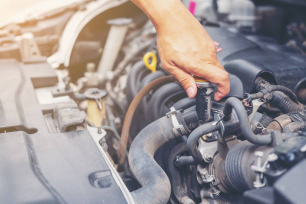 istock Man hand technician checking or fixing the engine of a modern car. Mechanic performing maintenance and car self fixing or maintenance. 1014935888