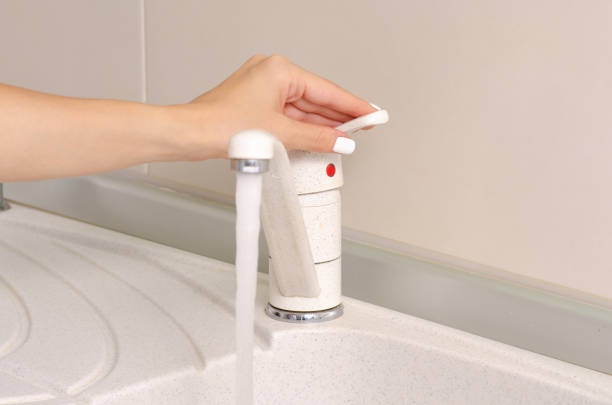 istock In the kitchen, a sink faucet water hand 1014946624