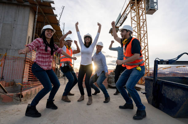 istock Happy group of architects celebrating at a construction site 1014950852