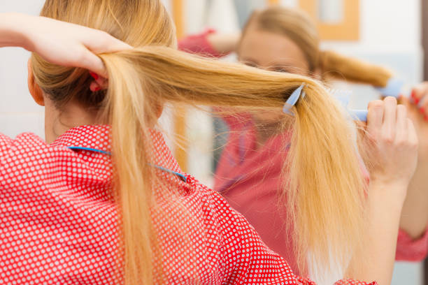 istock Woman combing her long hair in bathroom 1014950940