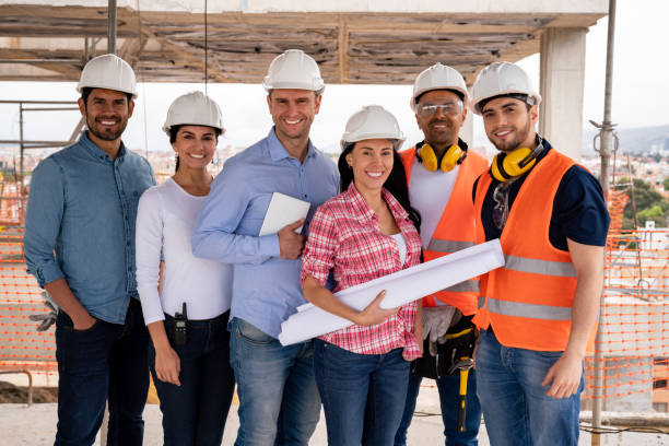 istock Group of architects looking happy at a construction site 1014951010