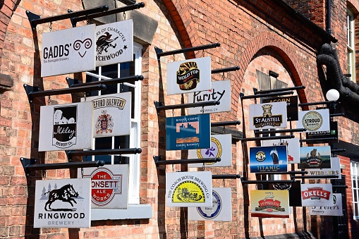 Brewery and beer signs on the wall outside the National Brewery Museum in Horninglow Street, Burton upon Trent, Staffordshire, England, UK, Western Europe.