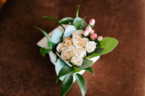 istock Wedding rings, gift box and flowers for the bride 1014958560