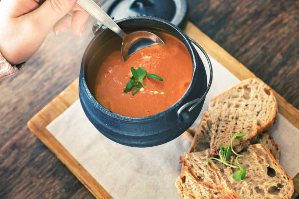 istock Hand stirring soup in cast-iron serving pot 1014961980