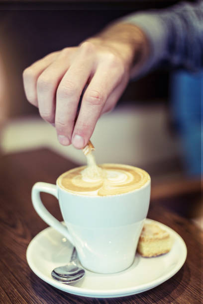 istock Male hand stirring cappuccino 1014962056