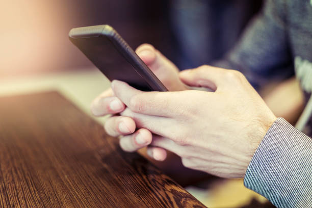 istock Cropped close-up of man texting on mobile phone 1014965524