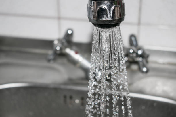 istock Concept water saving at home, reducing use. Water tap with flowing water with spray. Selective focus 1014974014