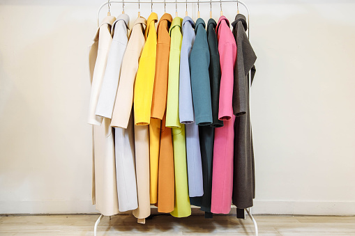 Mix color row of female coats on hangers
