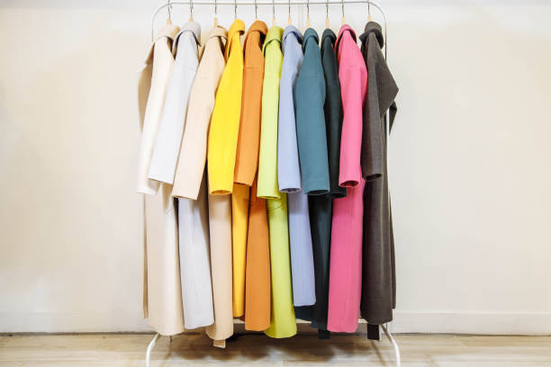 mix color row of female coats on hangers. - coat imagens e fotografias de stock