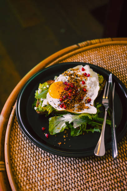 istock Avocado toast with egg on black plate 1014980284