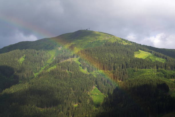 istock Rainbow over valley with Schattberg Mountain, Saalbach-Hinterglemm, Austria 1014982756