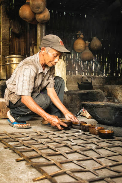 istock Senior artisan Indonesian palm sugar maker in kitchen 1014986926
