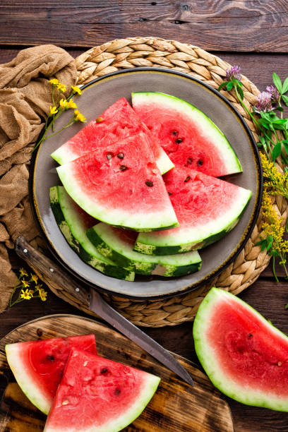 istock Watermelon. Fresh watermelon slices on plate on wooden rustic background 1014991512