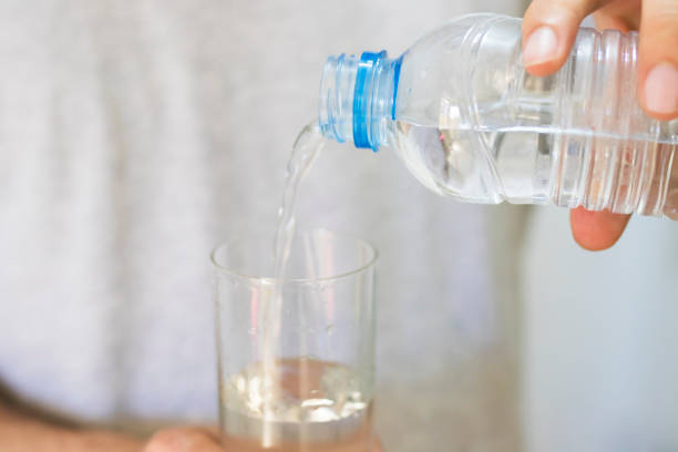 istock hands with a glass of water 1014996924