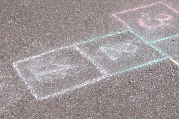 istock Hopscotch game on asphalt in Park. Painted with colorful chalks. 1015007598