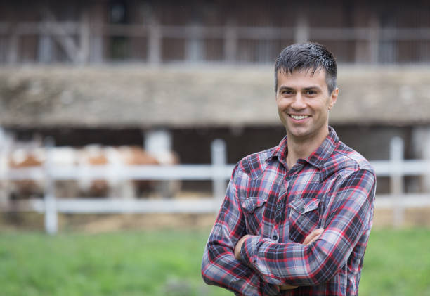 istock Farmer in front of cows on ranch 1015008396
