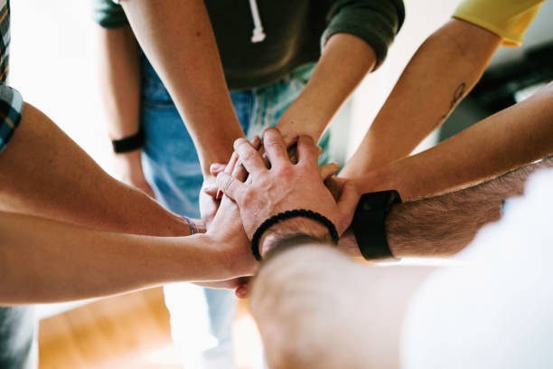 istock Group of people joining hands together. College students teamwork stacking hands.
Young entrepreneurs brainstorming on the new ideas. Teamwork unity and solidarity. Business cooperation. 1015010522