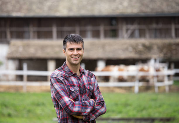 istock Farmer in front of cows on ranch 1015010532