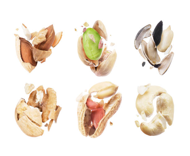 Set of broken nuts and seeds close-up on white background Set of broken nuts and seeds close-up on white background almond slivers stock pictures, royalty-free photos & images