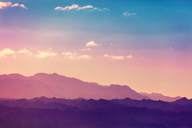 Sunset over mountains. Silhouette of a mountain range against sky at sunset