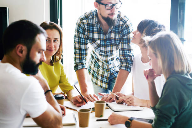 istock E-com specialists team is brainstorming new ideas for the new business project promotion. Young entrepreneurs are working on the sales project at the modern coworking space. 1015016358
