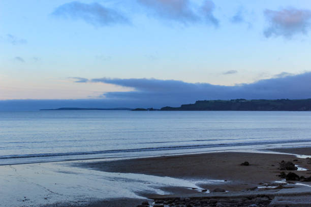 Tide coming in on a beach in the evening