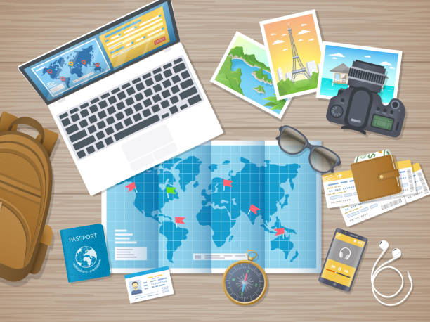 istock Preparing for vacation, travel, journey. Travel planning, packing check list.  Booking hotel. Wooden table with world map, photos, air ticket, passport, baggage, wallet, camera, compass, passport. 1015019188