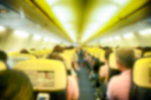 istock Blurred background  Interior of airplane with passengers on seats 1015037966