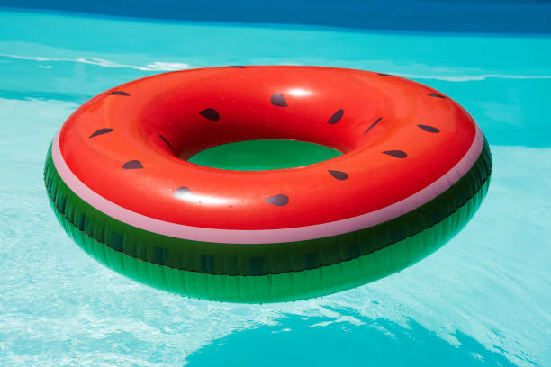 istock Inflatable watermelon ring in pool on sunny day 1015041962