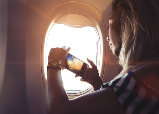 istock Taking photo by mobile phone from Airplane 1015042354