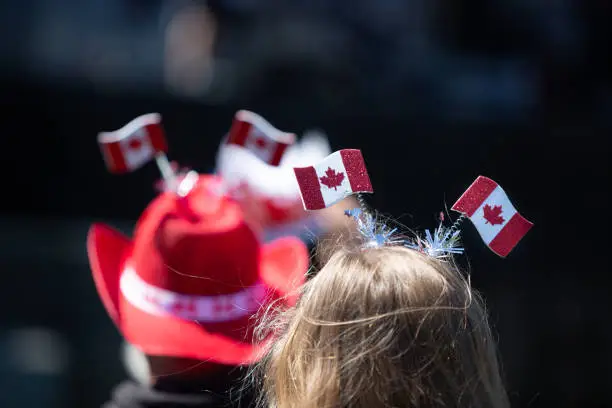 Celebrating Canada Day with a headdress made of Canada flags. Non-Identifiable people