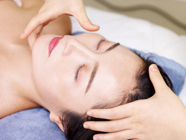 istock young asian woman enjoying a face massage 1015045904