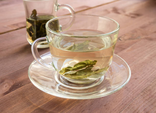istock Pancakes and a cup with Chinese green tea on the table 1015055046