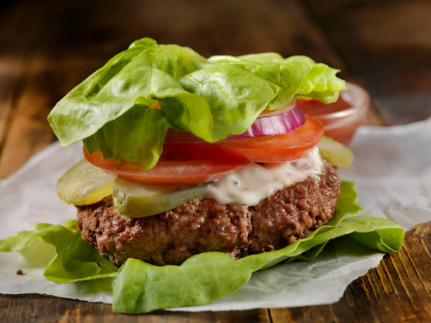 Low Carb - Lettuce Wrap Burger Low Carbohydrate - Lettuce Wrap Burger with Tomato, Onion and Mayo appetizer plate stock pictures, royalty-free photos & images