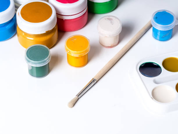 istock Jars with paint for drawing and brush on a white background 1015058580