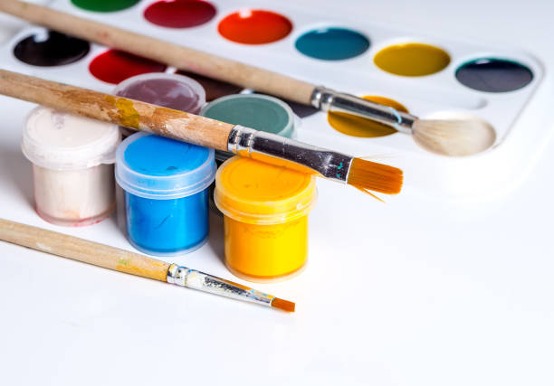 istock Gouache, brushes and watercolors on a white background 1015058596
